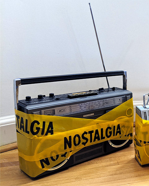 Art installation, Vintage Boombox, wrapped in custom yellow hazard tape, with the warning NOSTALGIA on, Zeitwarp