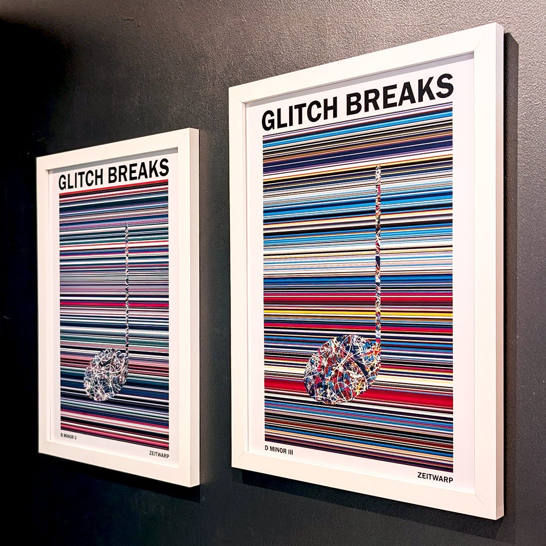 Pair of multicoloured Music Art prints in white frames on a metallic grey painted gallery wall
