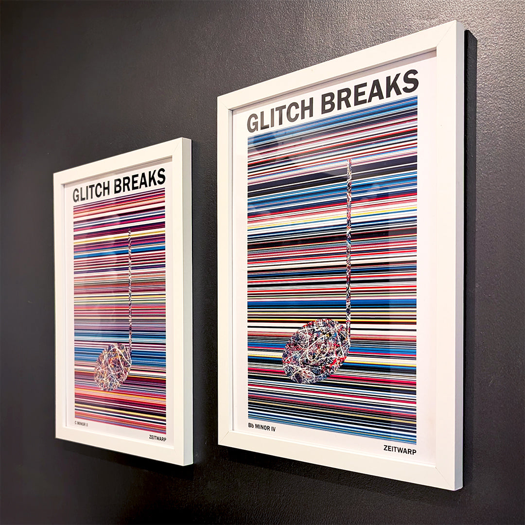 A pair of multicoloured Music Art prints in white frames on a grey painted gallery wall
