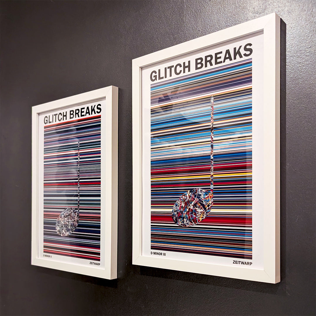 Pair of multicoloured Music Art prints in white frames on a metallic grey painted gallery wall