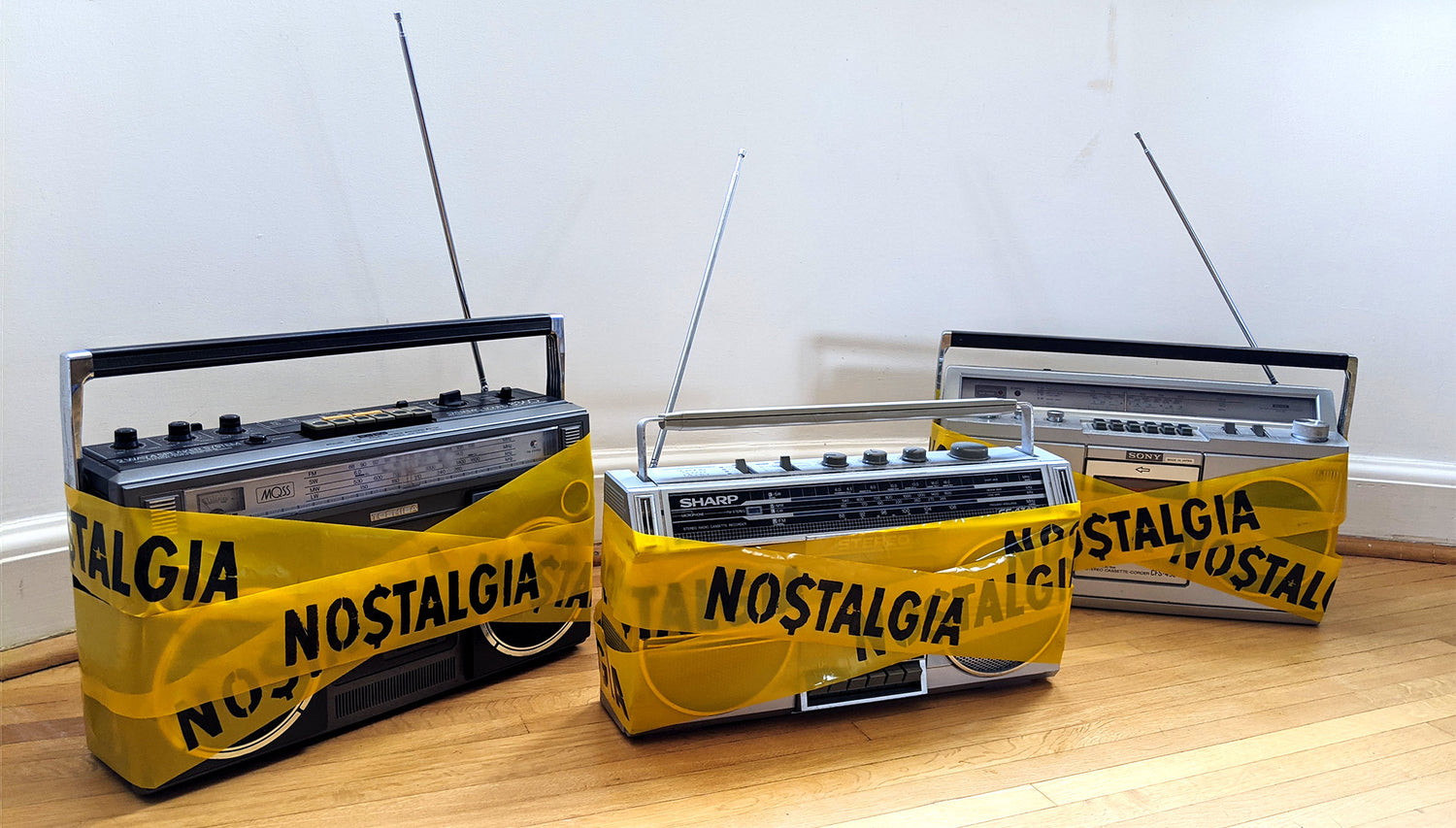 Art installation, Vintage Boomboxes, wrapped in custom yellow hazard tape, with the warning NOSTALGIA on, Zeitwarp