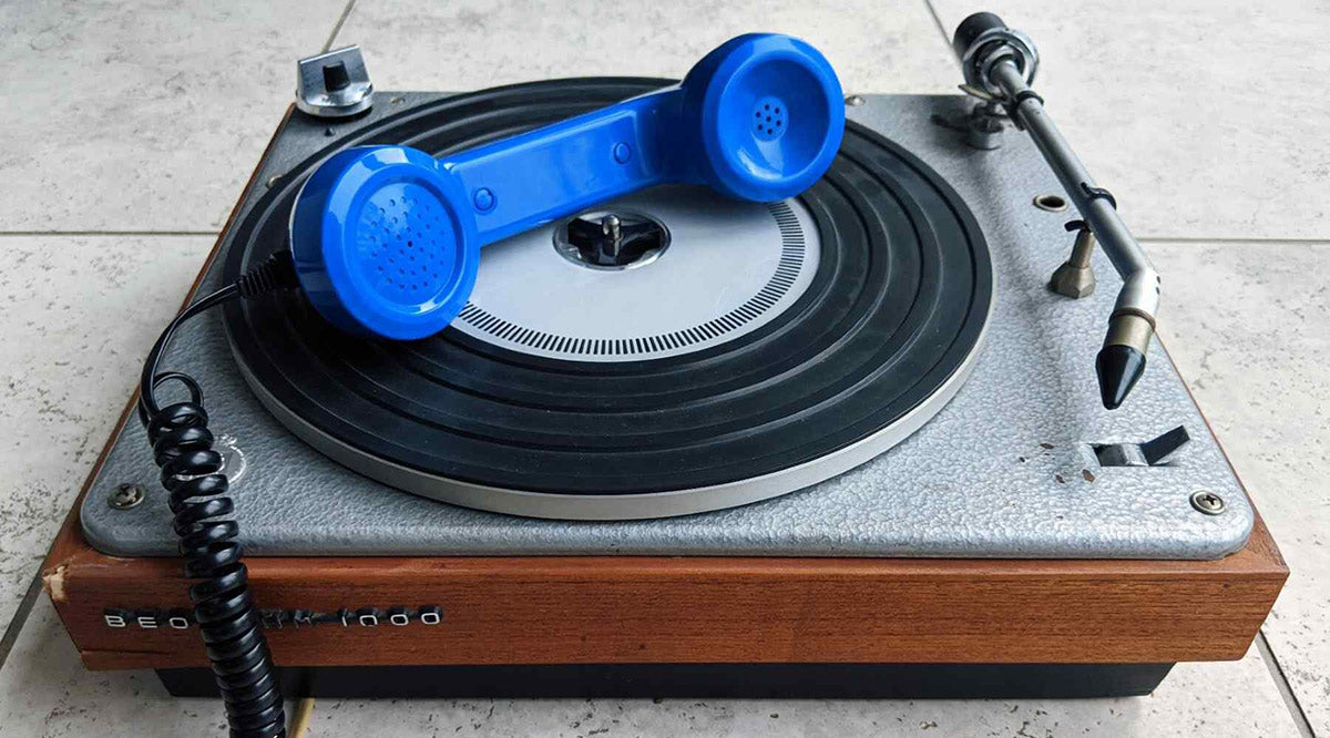 Retro blue telephone handset on a vintage bang & olufsen turntable