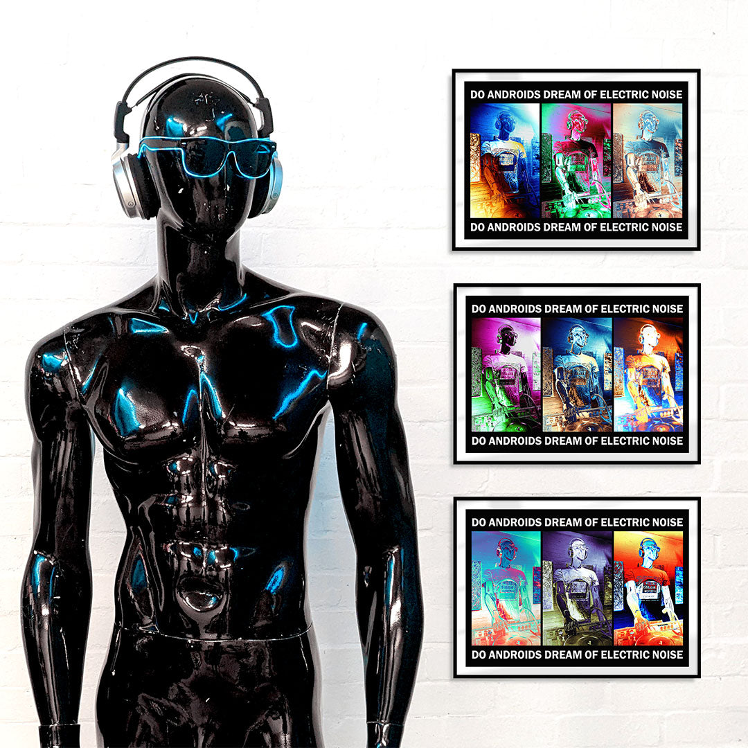 A futuristic black mannequin with sunglasses and headphones standing in front of four framed photos on a white wall