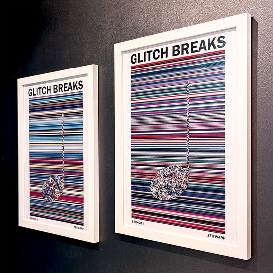 A pair of multicoloured Music Art prints in white frames on a metallic grey painted wall