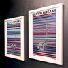 A pair of multicoloured Music Art prints in white frames on a metallic grey painted wall