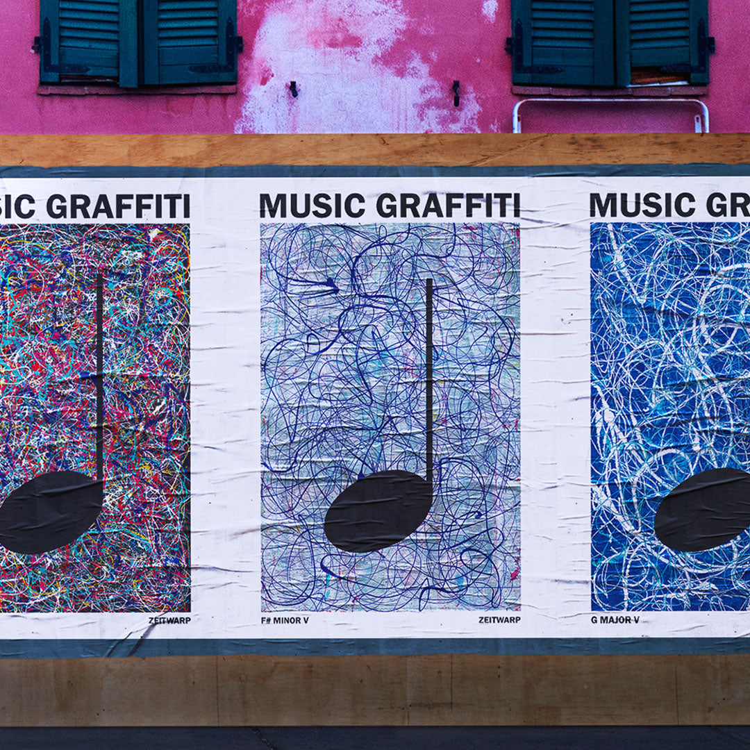 Glued posters on a brick wall showing Music Graffiti images in a street scene