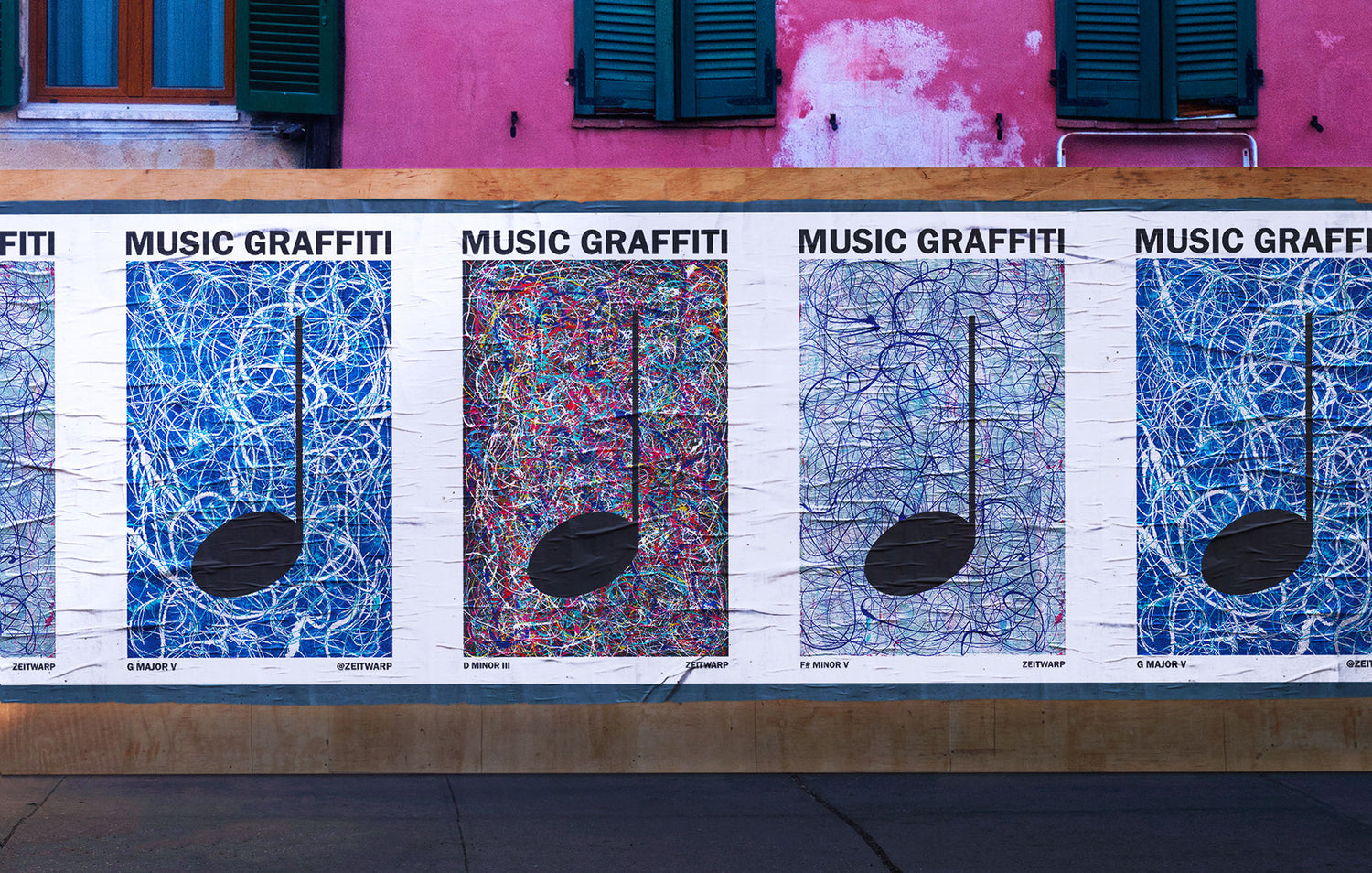 Glued posters on a brick wall showing Music Graffiti images