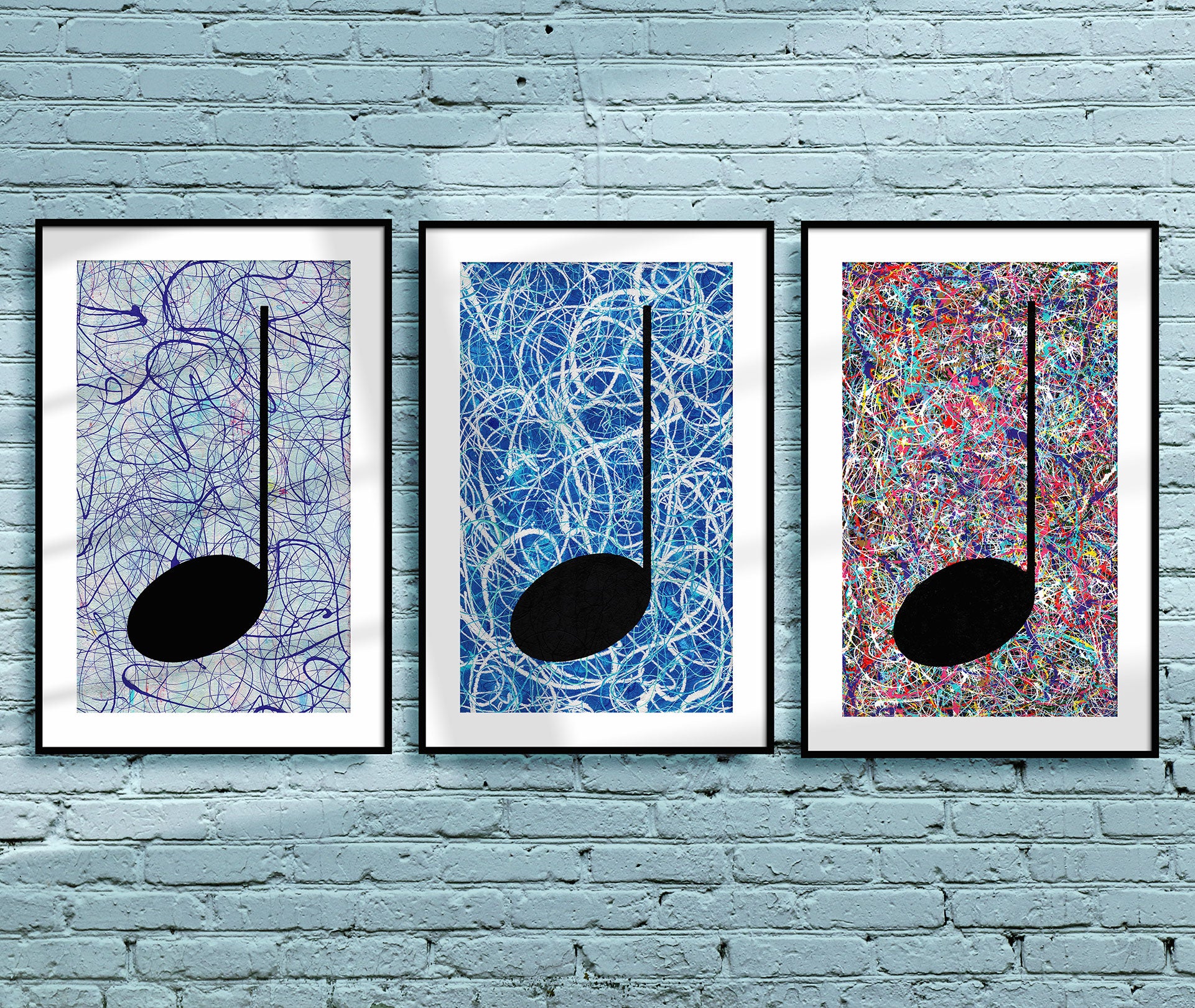 Three Music Art Prints, Framed and hanging on a light blue brick wall