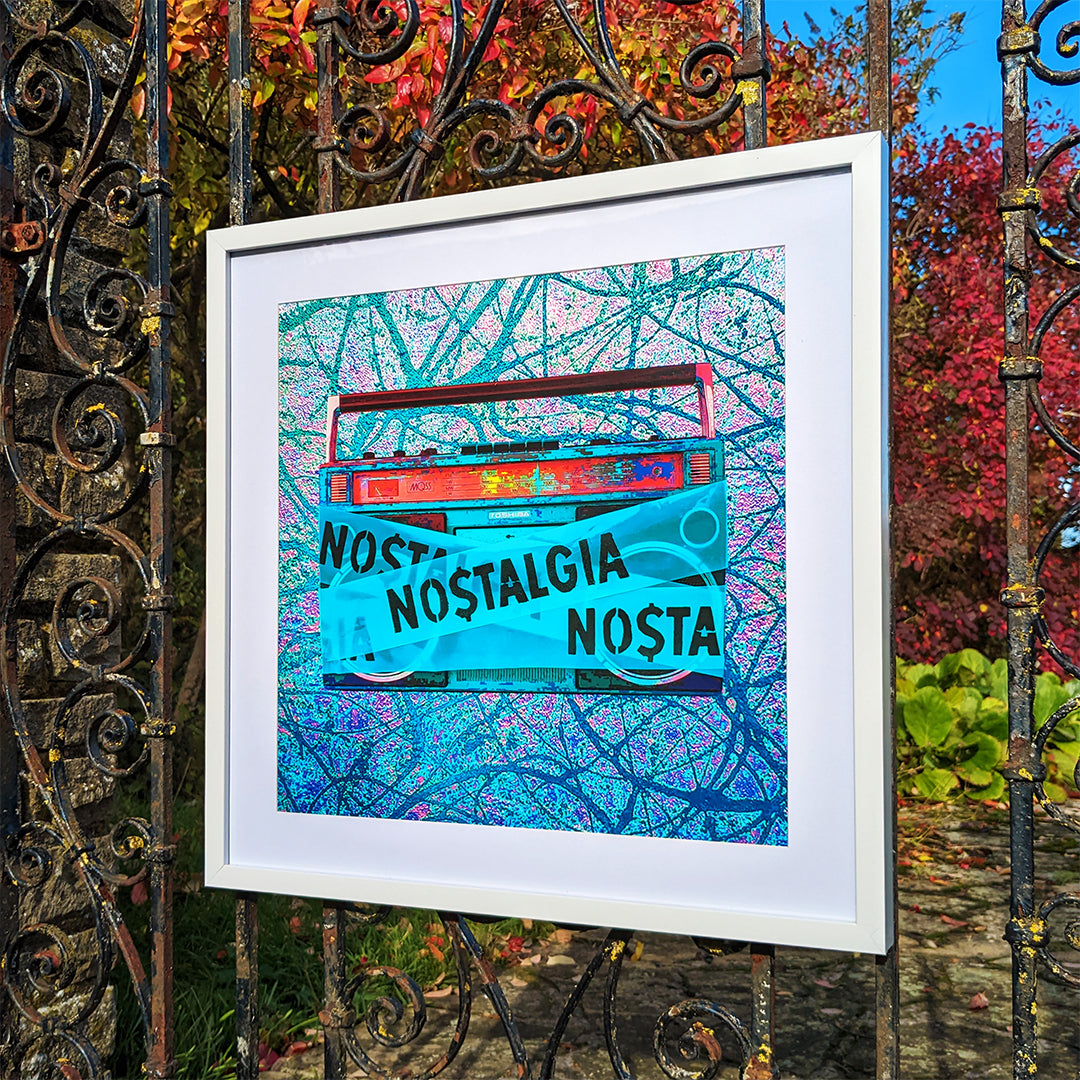 Framed print hanging on an old iron gate