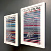 A pair of multicoloured Music Art prints in white frames on a metallic grey painted wall