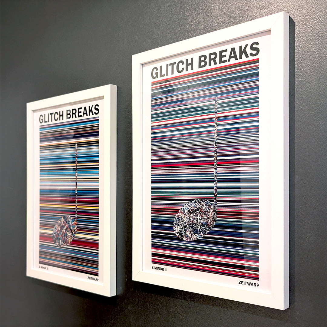 A pair of multicoloured Music Art prints in white frames on a metallic grey painted wall