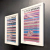 A pair of multicoloured Music Art prints in white frames on a metallic grey painted gallery wall