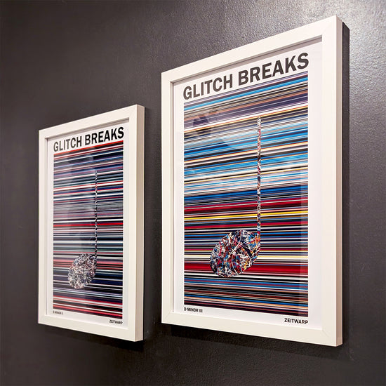 Pair of multicoloured Music Art prints in white frames on a metallic grey painted gallery wall